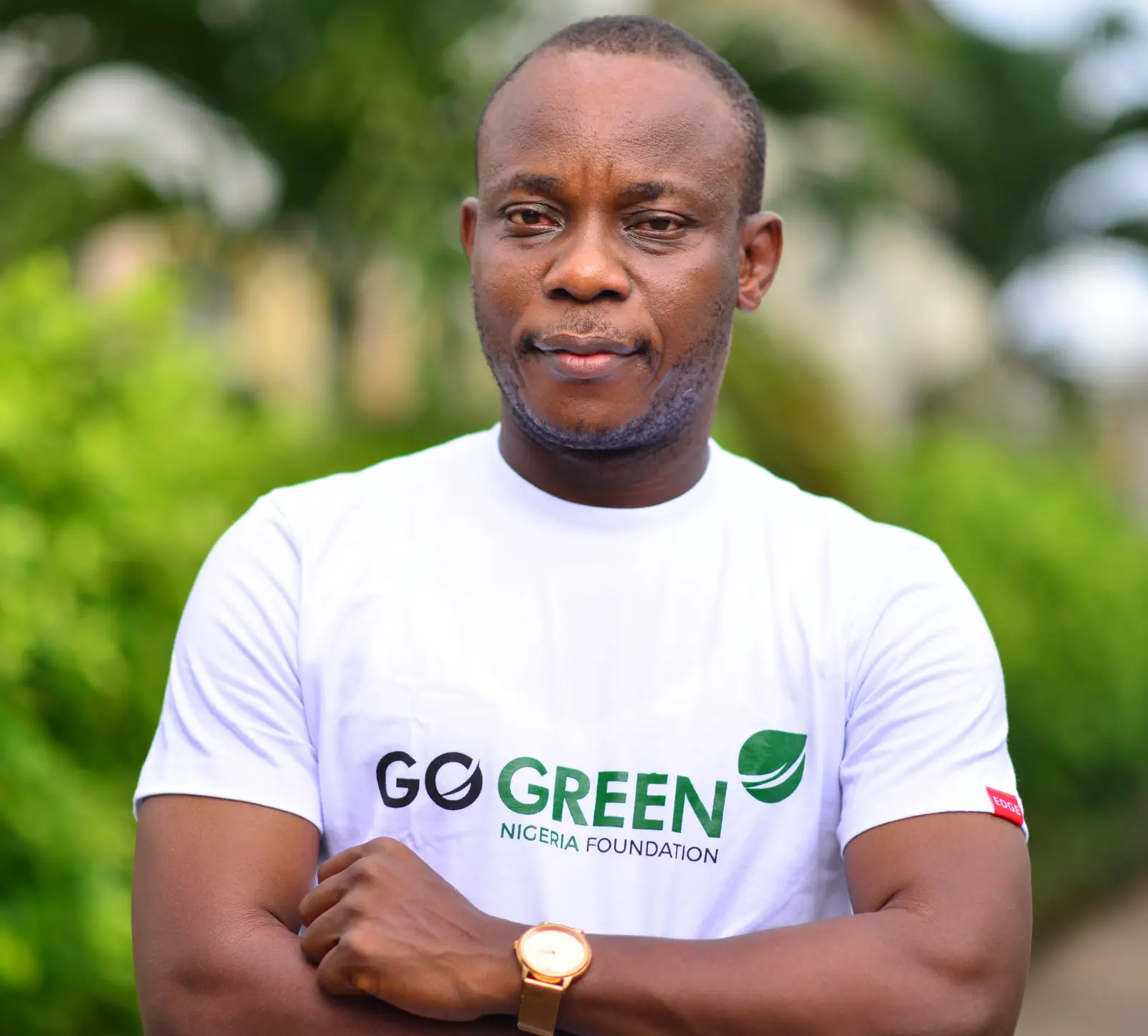 A Go Green Nigeria Foundation team member wearing the foundation's shirt