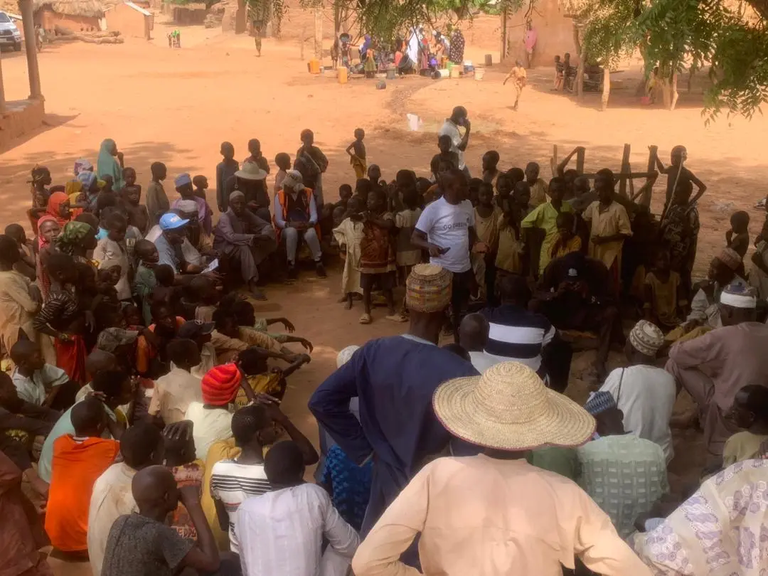 Residents seated in a circle at a community meeting