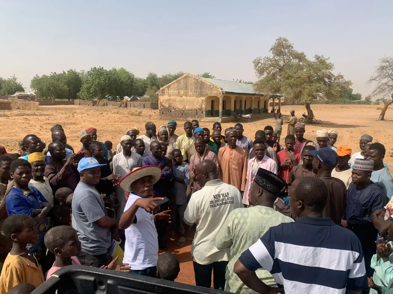 A foundation volunteer addressing residents in an open square