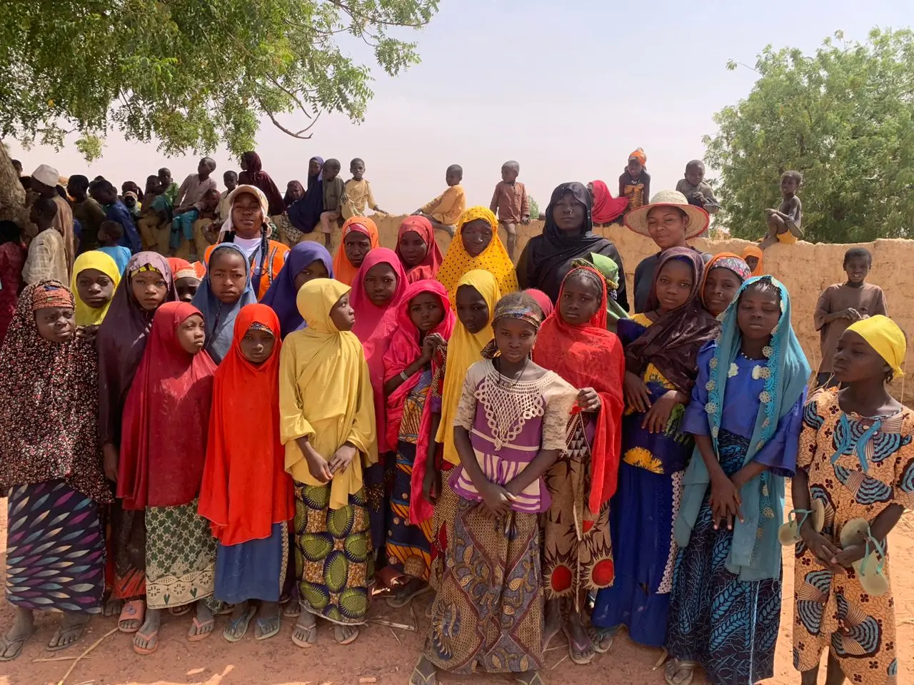 Women and children gathered at a community visit