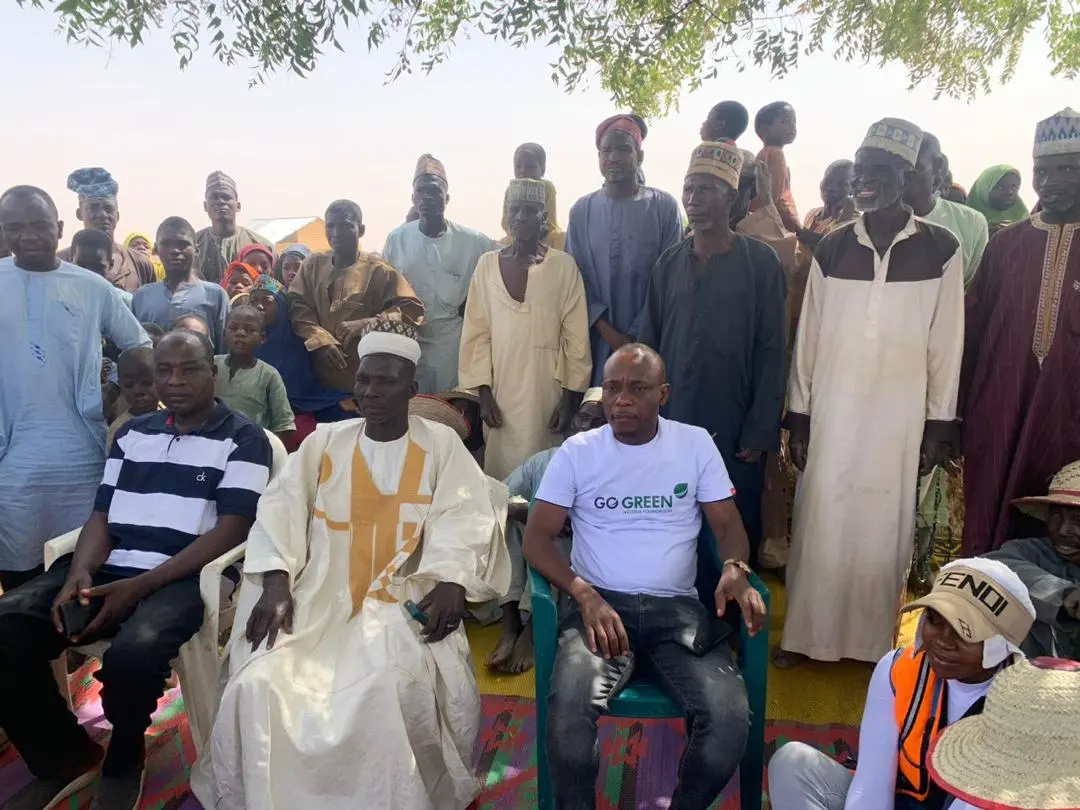 Community leaders and foundation staff seated together at a village gathering
